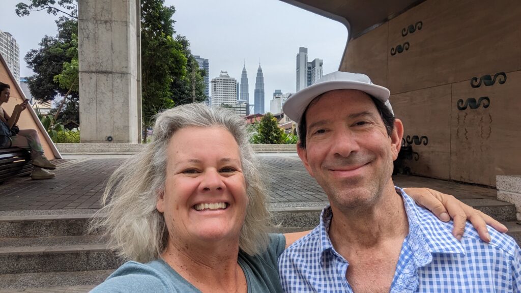 handsome couple in front of patronas towers, malaysia
